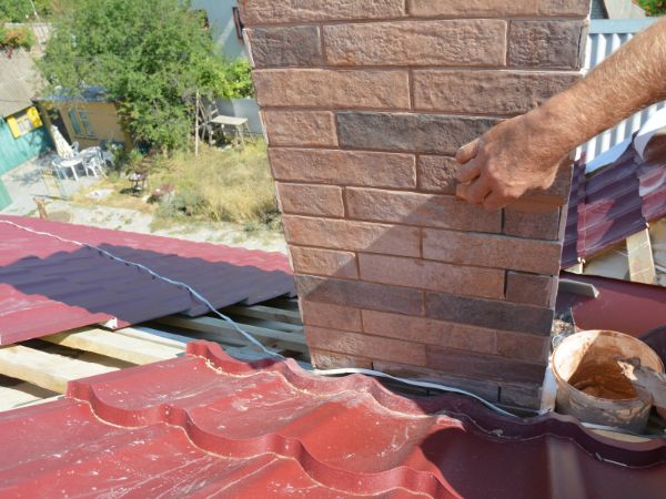 Man tuckpointing a chimney, Elm Grove, WI.