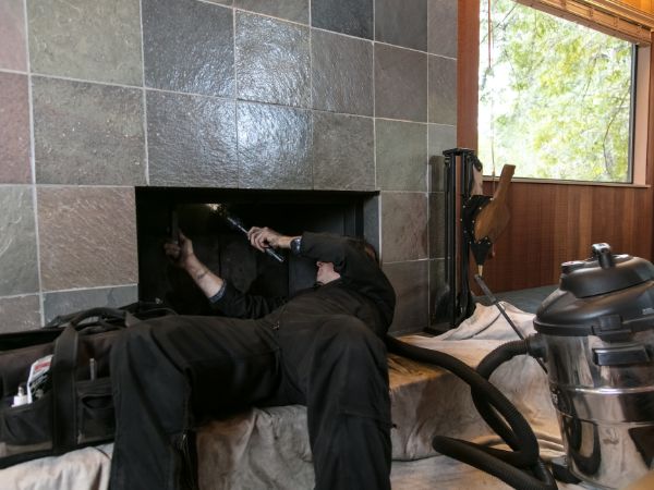 Man performing a chimney inspection, Elm Grove, WI.