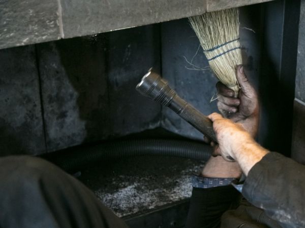 Man performing chimney services, Brookfield, WI.