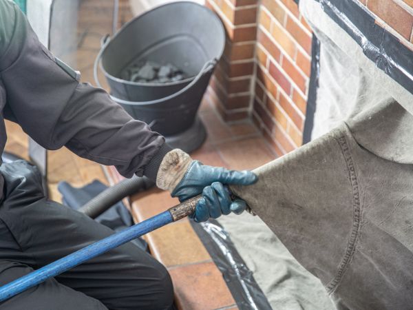 Man performing chimney sweeping in Elm Grove, WI.